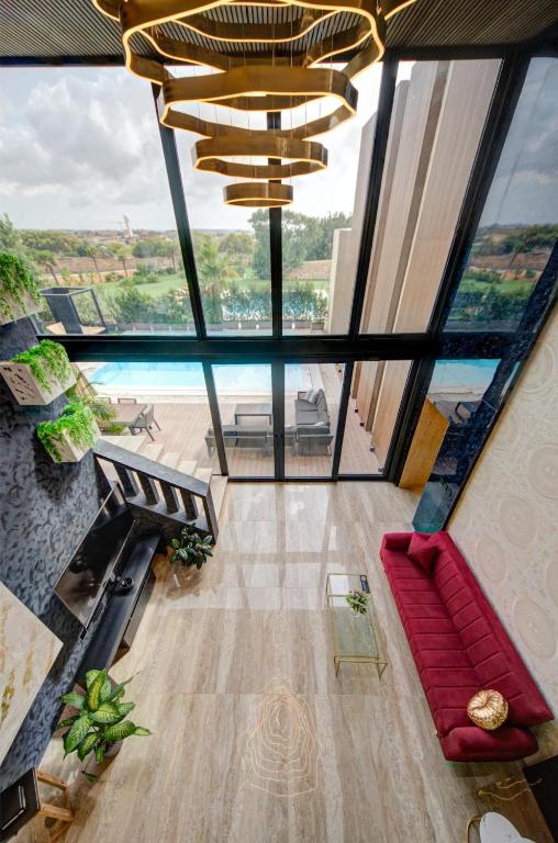 The double-height living room looking out to the terrace and pool