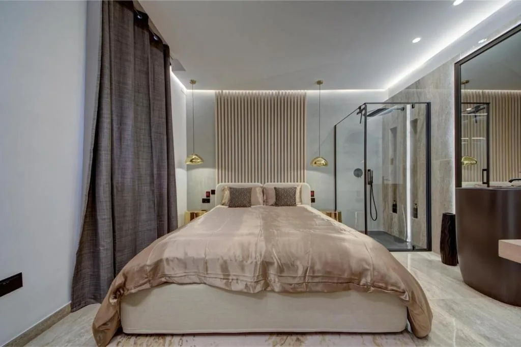 A bedroom looking through to the bathroom
