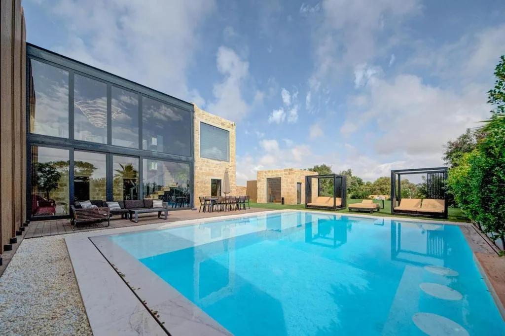 The outdoor pool below the double-height glass wall