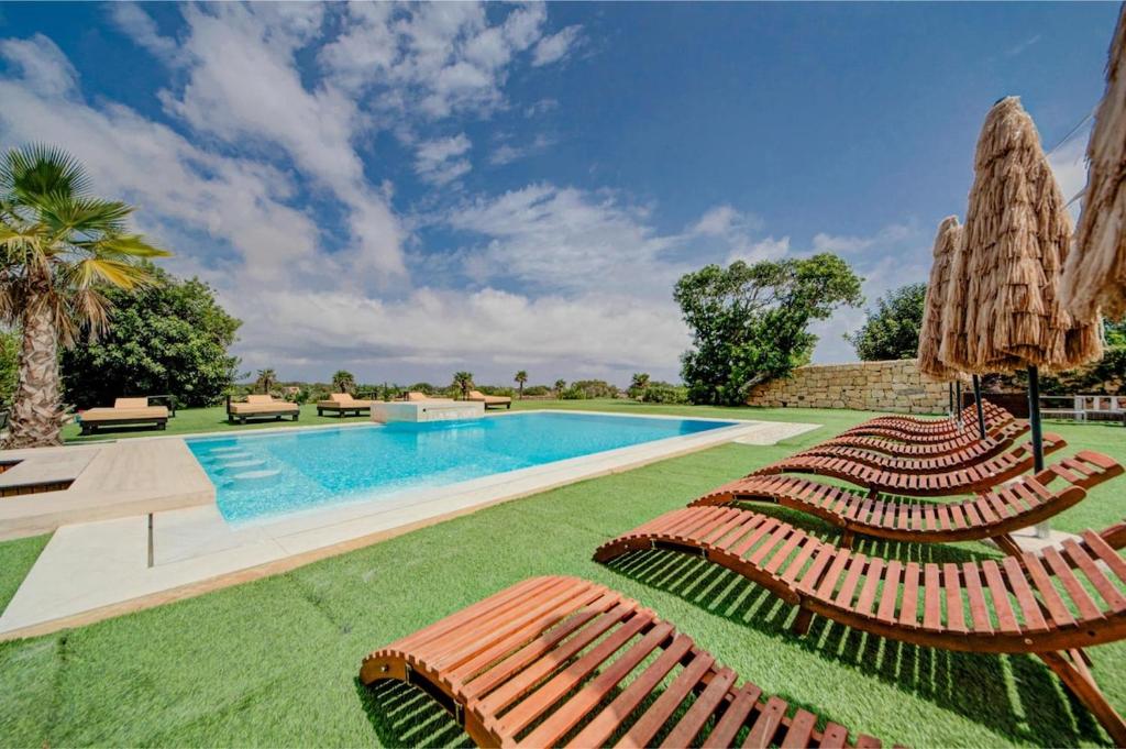 The outdoor pool and its limestone deck, cut into the lawn
