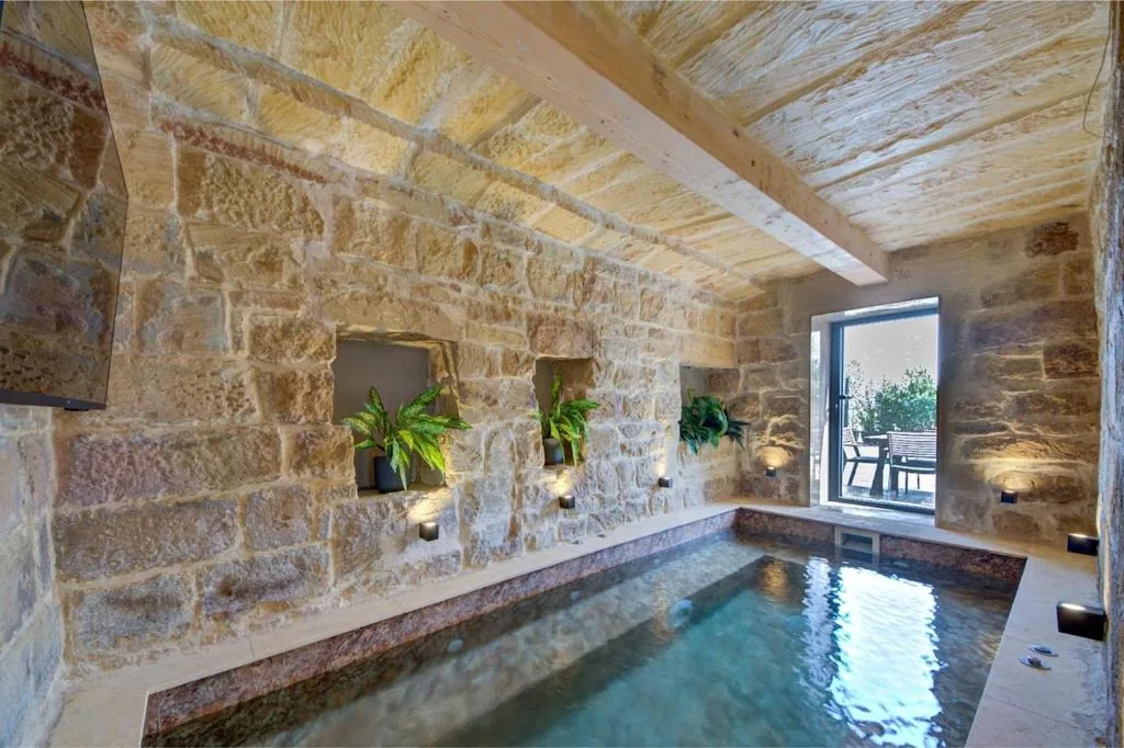 The second indoor pool, in a vaulted room of bare limestone